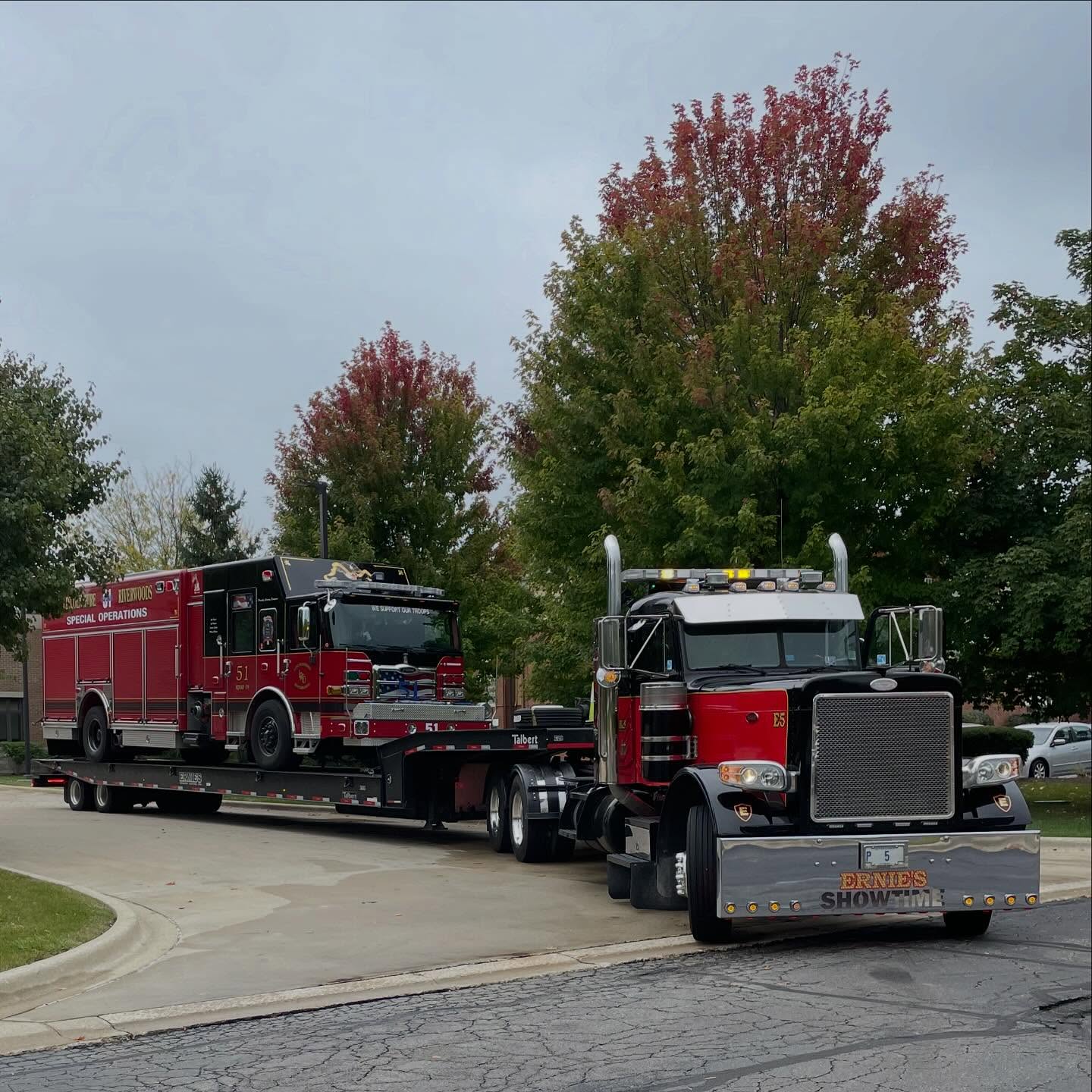 Lowboy transport hauling a fire truck